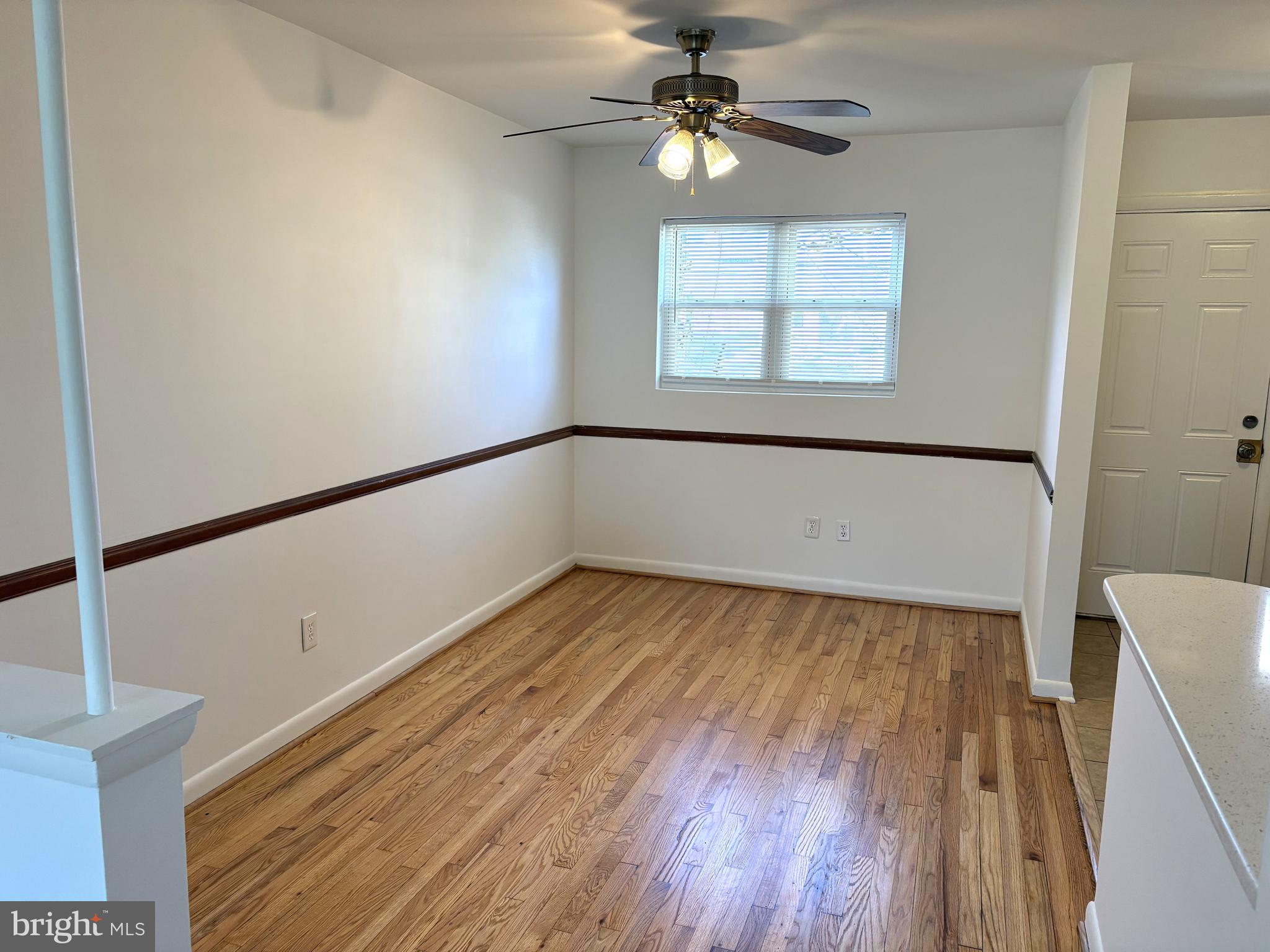 3820 2nd Street Baltimore, MD 21225 - Photo 4 of 23 a view of empty room with wooden floor and fan