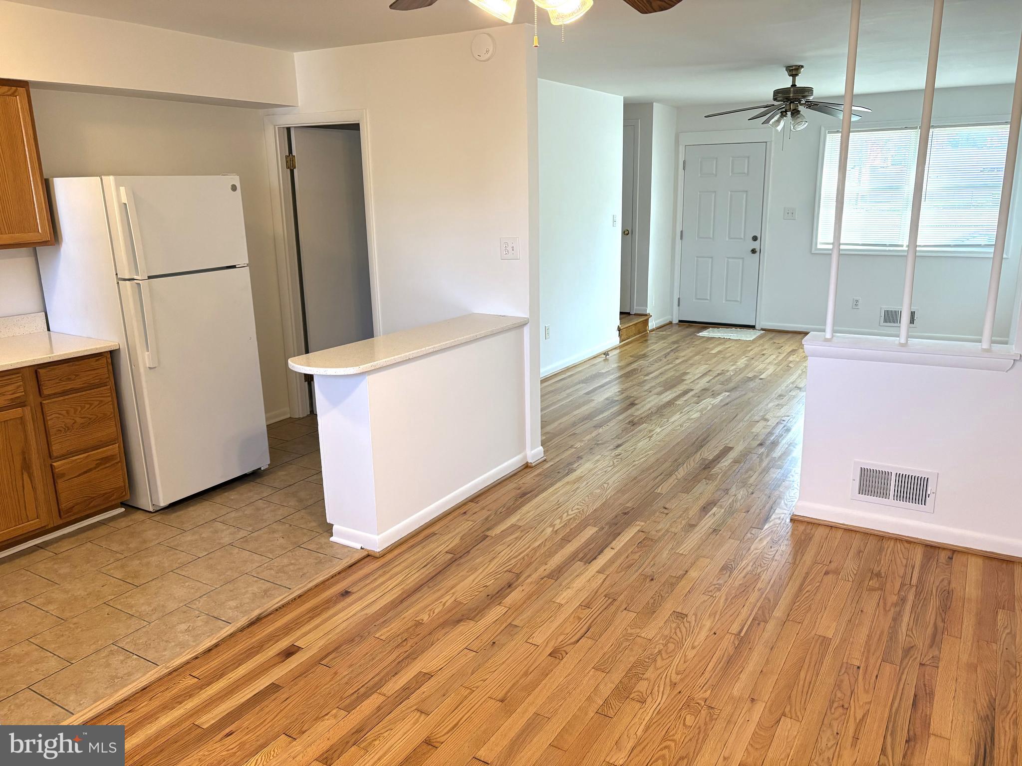 3820 2nd Street Baltimore, MD 21225 - Photo 5 of 23 a view of a refrigerator in kitchen and wooden floor