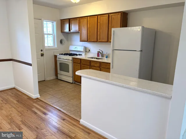 a kitchen with a refrigerator sink stove and cabinets