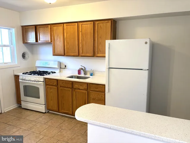 a white refrigerator freezer sitting in a kitchen