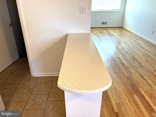 a view of a room with wooden floor