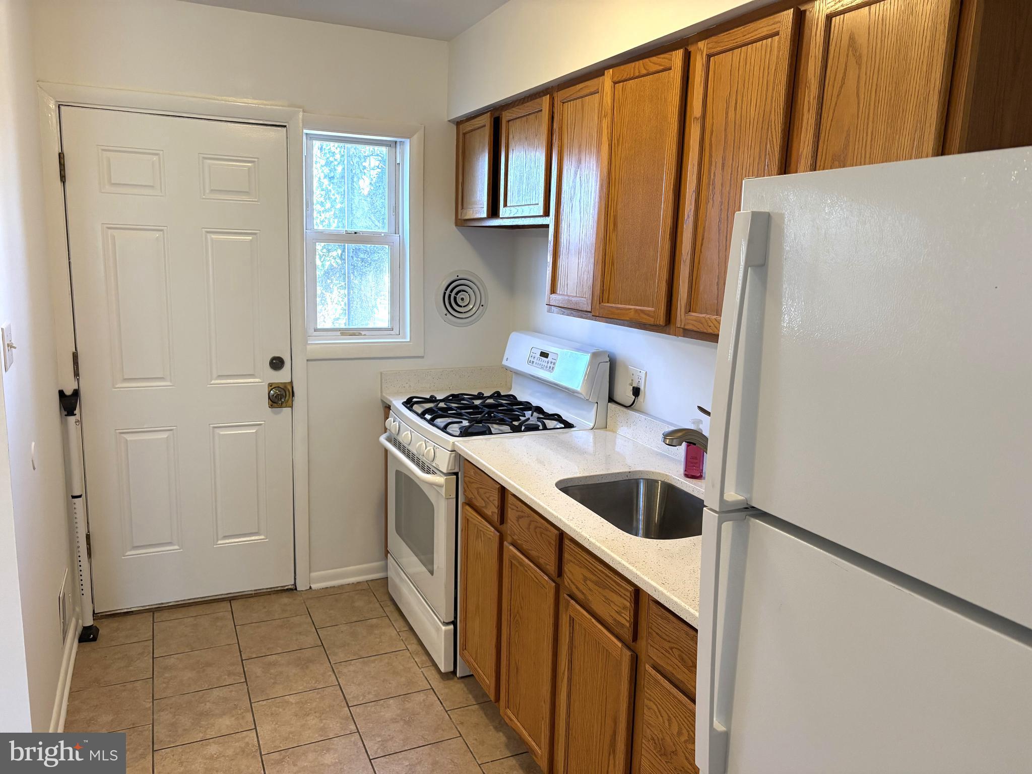 3820 2nd Street Baltimore, MD 21225 - Photo 9 of 23 a kitchen with a refrigerator and a sink