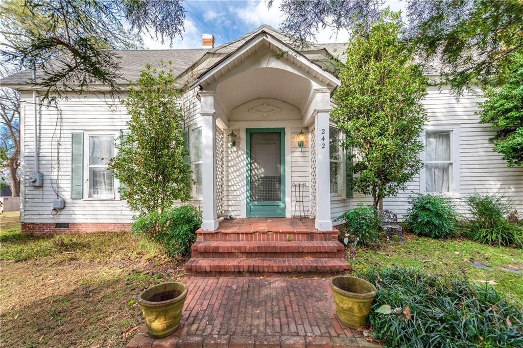 242 Calhoun Street Fairmount, GA 30139 - Photo 1 of 1 a front view of a house with garden