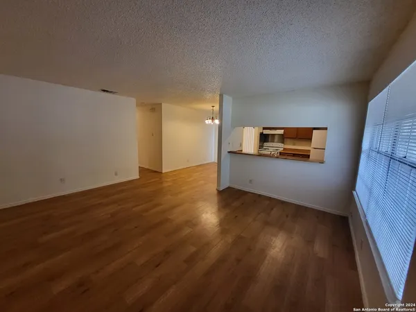 a view of a room with wooden floor and a window