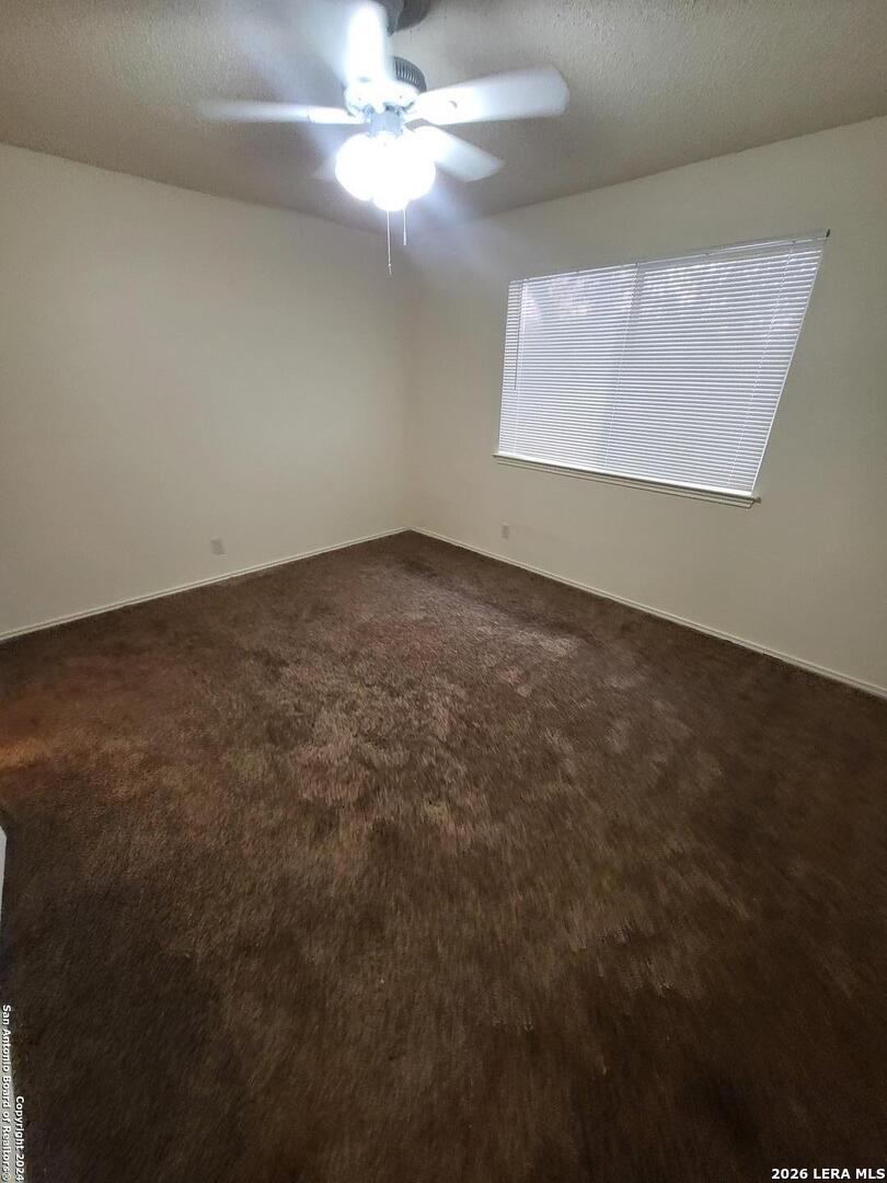 12204 Ridge Crown Street San Antonio, TX 78247 - Photo 8 of 10 en empty room with windows and fan