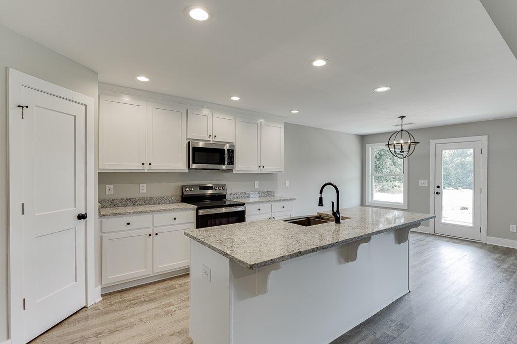 295 Anderson Thomas Road Martin, GA 30557 - Photo 11 of 44 a kitchen with granite countertop a sink a counter top space and cabinets