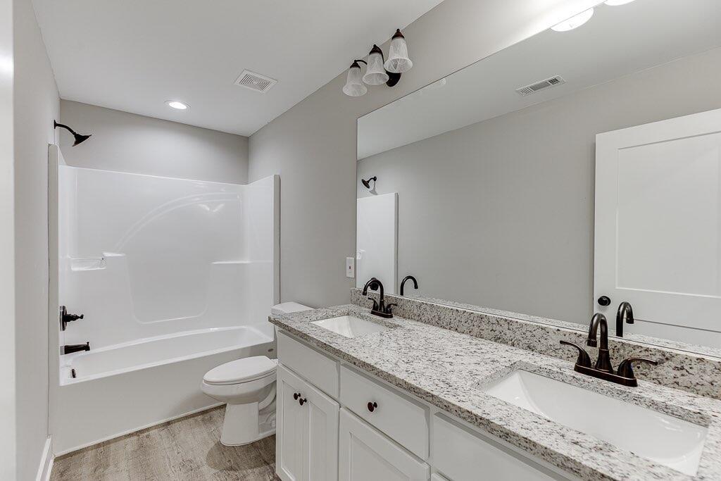 295 Anderson Thomas Road Martin, GA 30557 - Photo 18 of 44 a bathroom with a granite countertop sink a toilet and shower