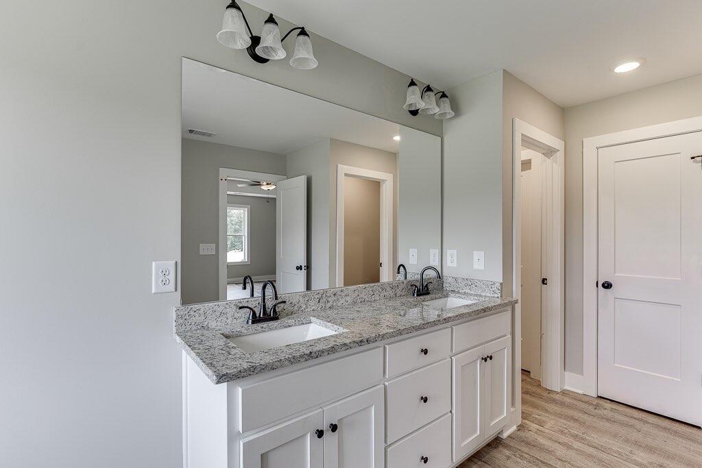 295 Anderson Thomas Road Martin, GA 30557 - Photo 27 of 44 a bathroom with a granite countertop sink and a mirror