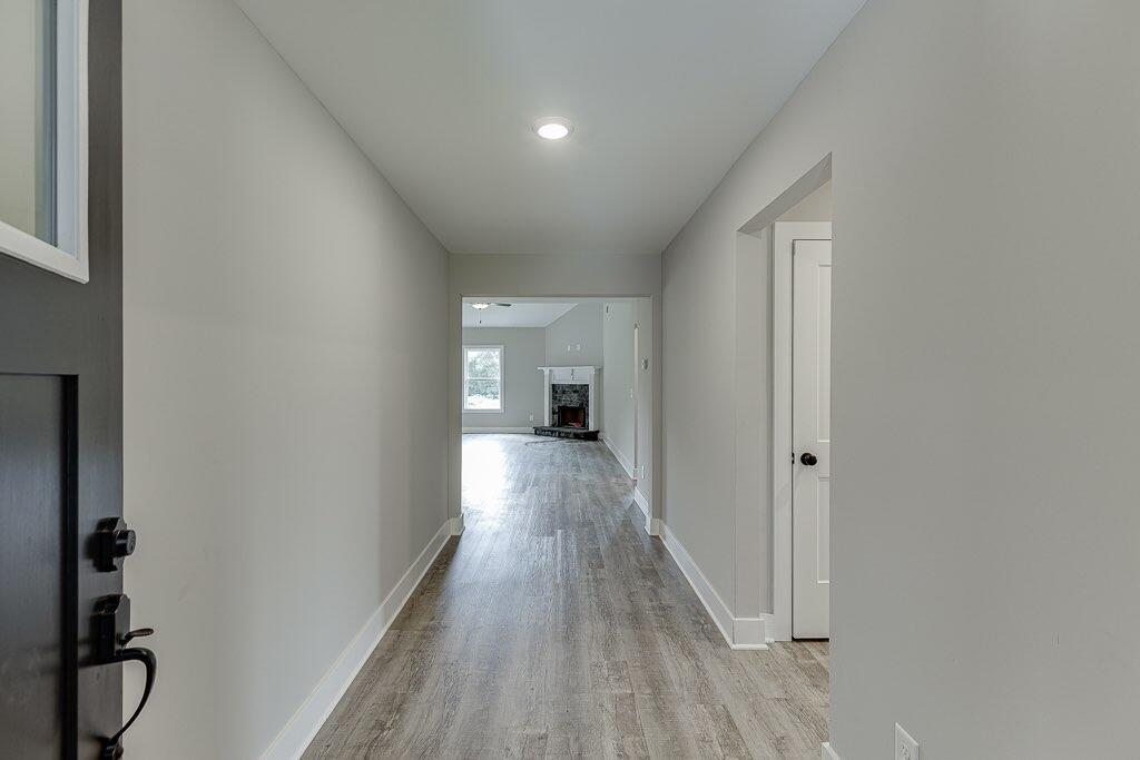 295 Anderson Thomas Road Martin, GA 30557 - Photo 5 of 44 a view of a hallway with wooden floor and staircase
