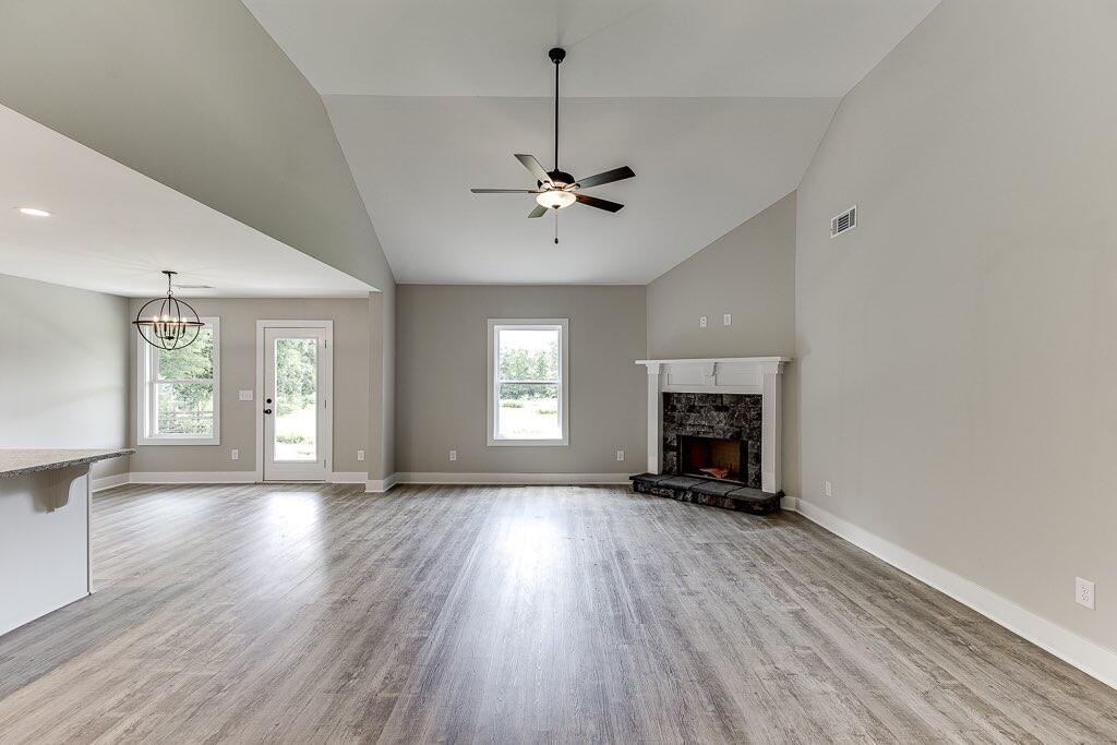 295 Anderson Thomas Road Martin, GA 30557 - Photo 9 of 44 a view of an empty room with a fireplace and a window