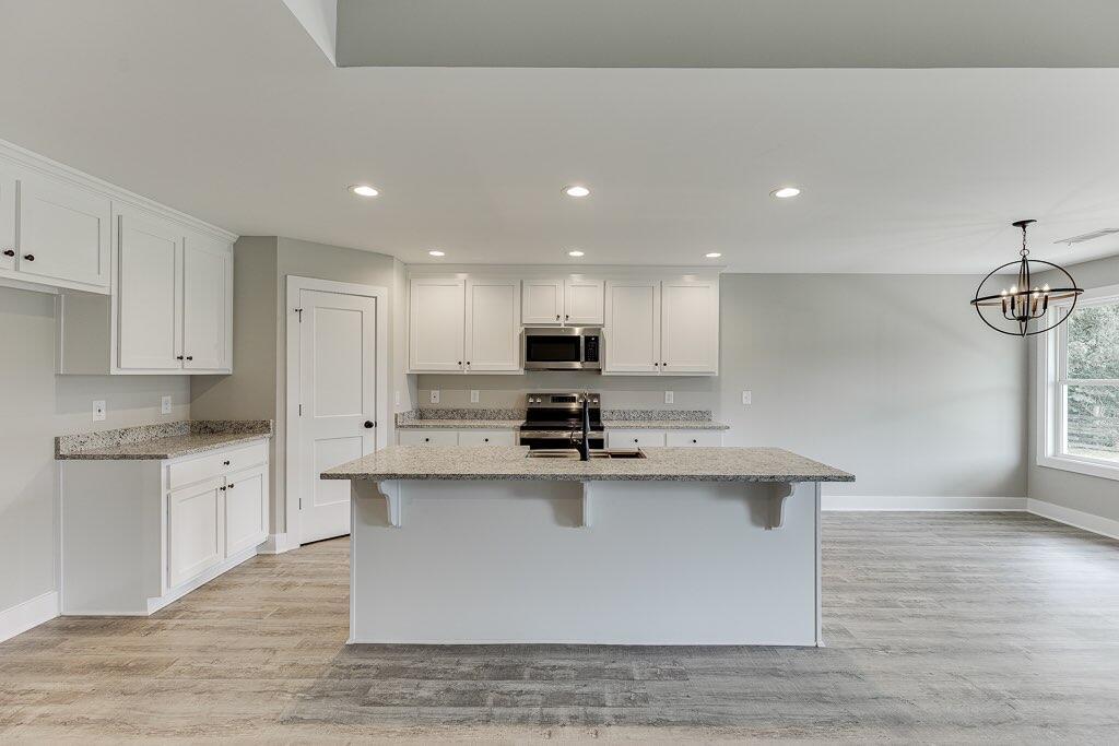 295 Anderson Thomas Road Martin, GA 30557 - Photo 10 of 44 a kitchen with stainless steel appliances granite countertop a sink a stove top oven a counter space and cabinets