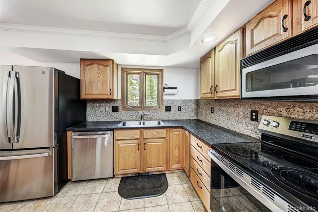 a kitchen with a sink stove and microwave