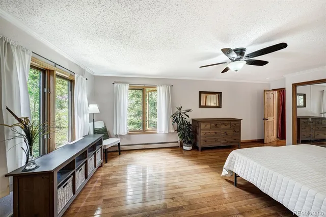 a bedroom with furniture and a large window