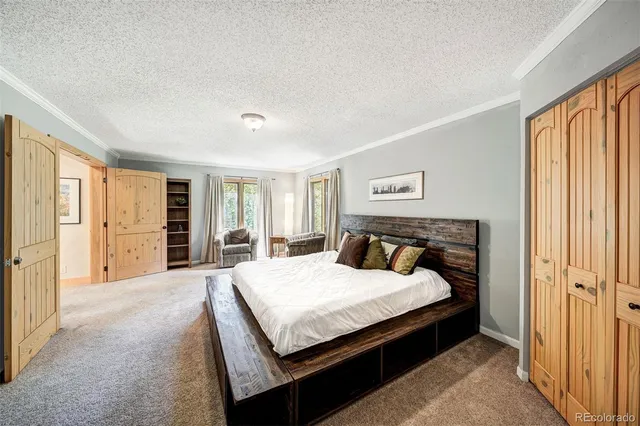 a bedroom with a large bed and a window