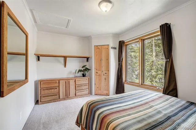 a bedroom with a bed and a large window