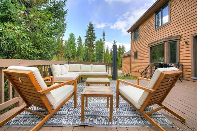 a view of a patio with a dining table and chairs