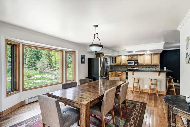 a dining room with furniture and wooden floor