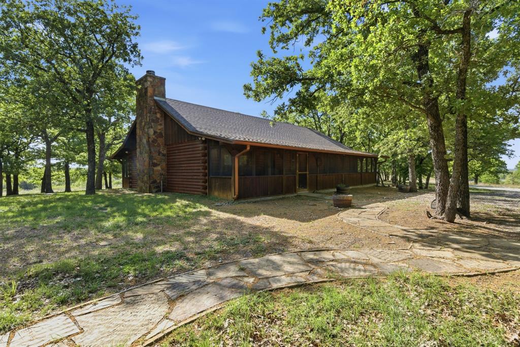 2197 Netherly Lane Forestburg, TX 76239 - Photo 19 of 40 a front view of a house with a yard and garage