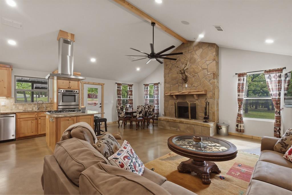 2197 Netherly Lane Forestburg, TX 76239 - Photo 25 of 40 a living room with furniture a fireplace and a flat screen tv