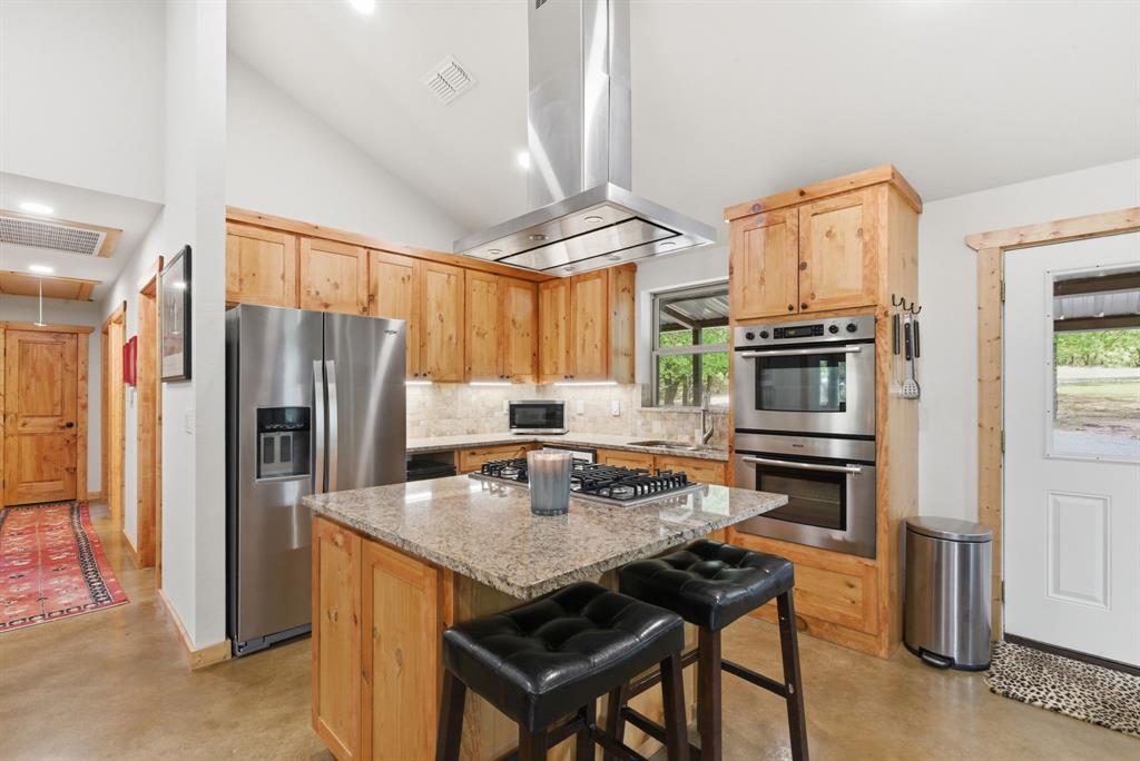 2197 Netherly Lane Forestburg, TX 76239 - Photo 26 of 40 a kitchen with a refrigerator a stove a sink and dishwasher