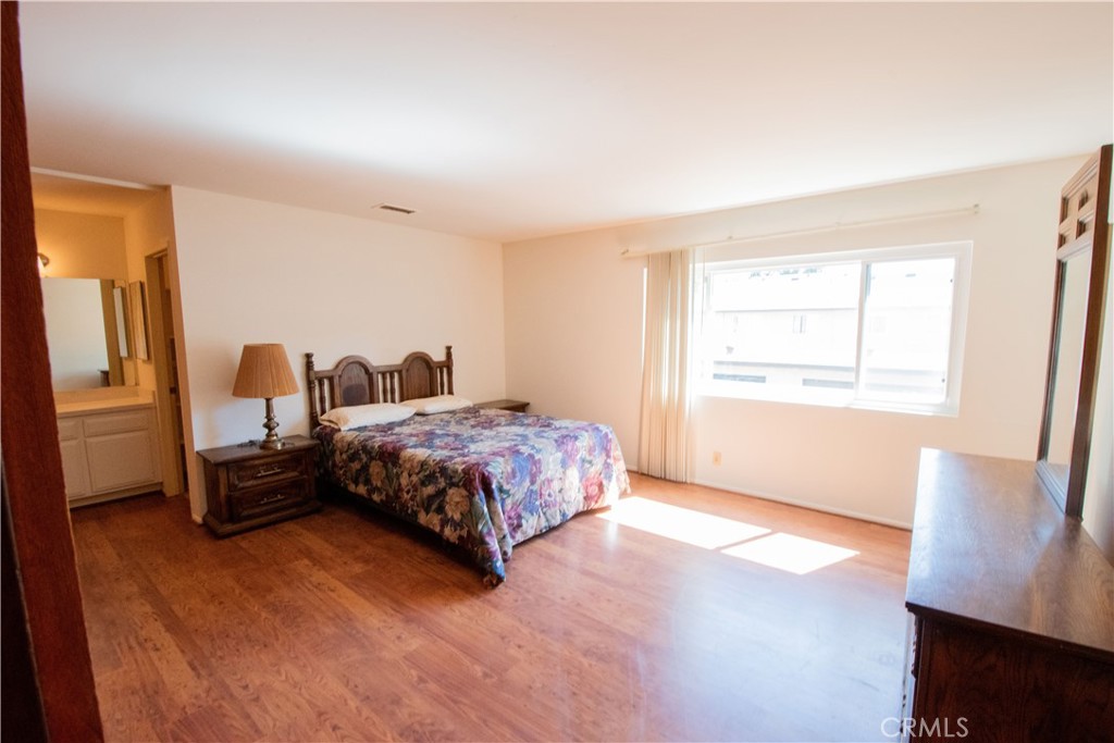 20135 Leadwell Street, Unit 2 Winnetka, CA 91306 - Photo 12 of 21 a bedroom with a bed and wooden floor