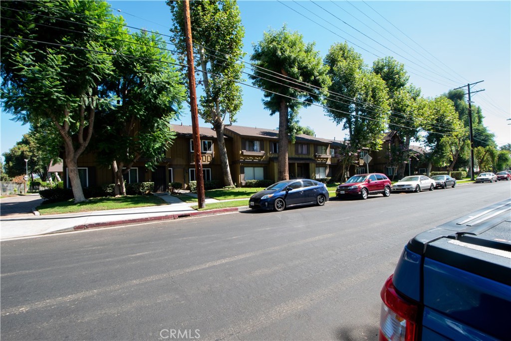 20135 Leadwell Street, Unit 2 Winnetka, CA 91306 - Photo 18 of 21 a view of road with card parked on side and retail shops