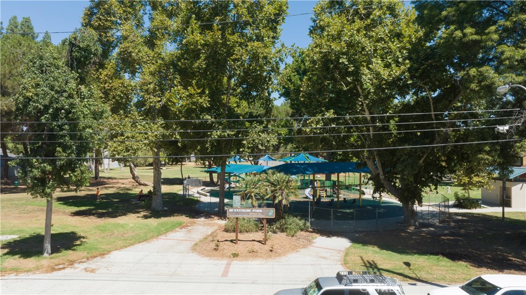 20135 Leadwell Street, Unit 2 Winnetka, CA 91306 - Photo 20 of 21 a backyard of a house with table and chairs under an umbrella