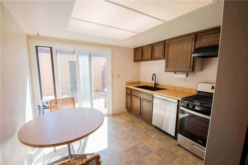 20135 Leadwell Street, Unit 2 Winnetka, CA 91306 - Photo 9 of 21 a kitchen with stainless steel appliances granite countertop a sink stove and cabinets