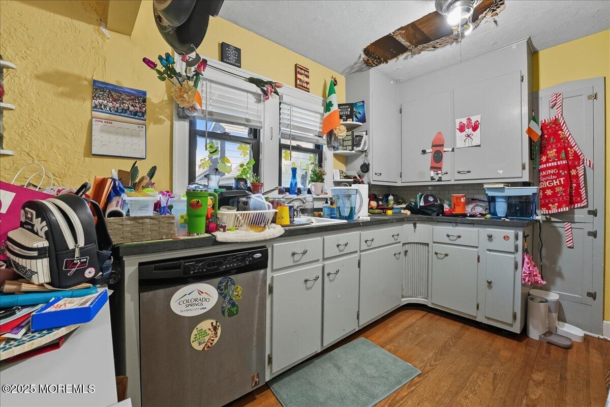 108 Pine Street Toms River, NJ 08753 - Photo 4 of 16 a kitchen with kitchen island granite countertop lots of clutter and stainless steel appliances
