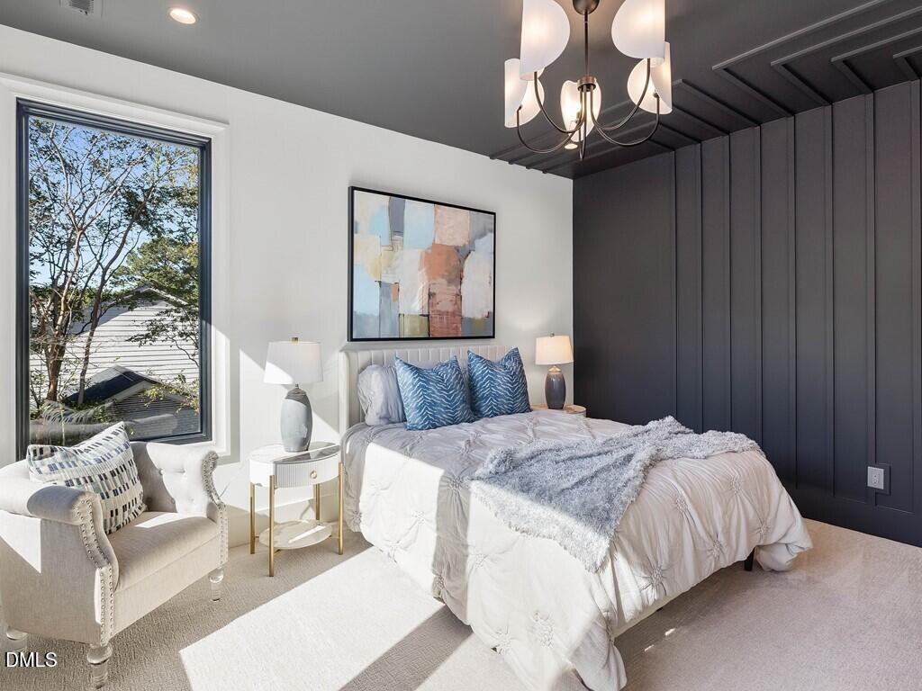 7013 Buckhead Drive Raleigh, NC 27615 - Photo 48 of 80 a bedroom with a bed couch chandelier and a window