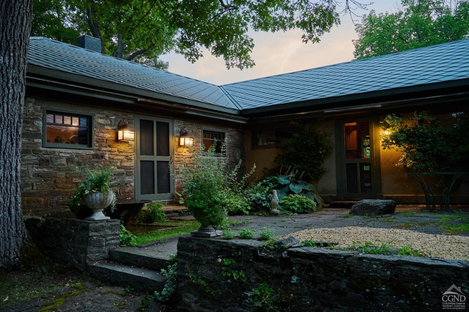 5280 Cauterskill Road Catskill, NY 12414 - Photo 51 of 55 a view of brick house with potted plants and a table and chairs