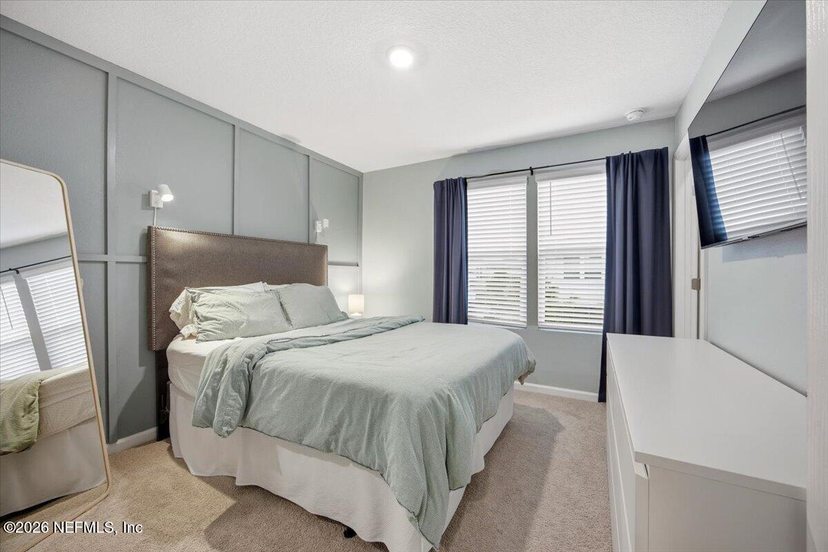 35 Hidden Mdws Road St. Augustine, FL 32095 - Photo 12 of 21 a bedroom with a large bed and a window