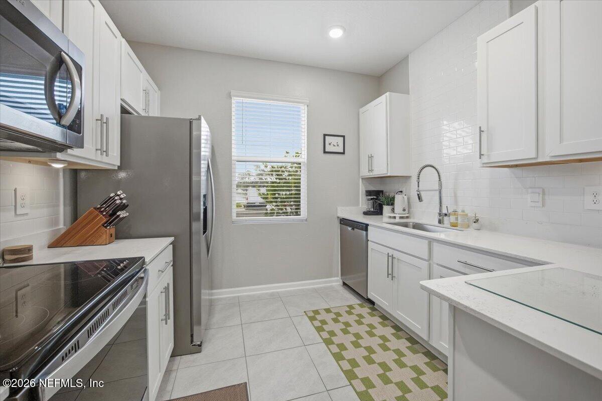 35 Hidden Mdws Road St. Augustine, FL 32095 - Photo 5 of 21 a kitchen with a sink stove and cabinets