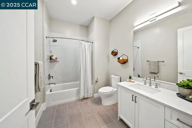 a bathroom with a double vanity sink toilet mirror and shower