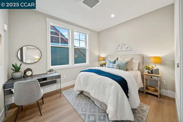 a bedroom with a bed and dresser with mirror