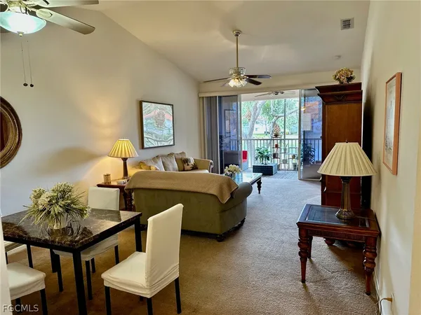 a living room with furniture a window and a flat screen tv