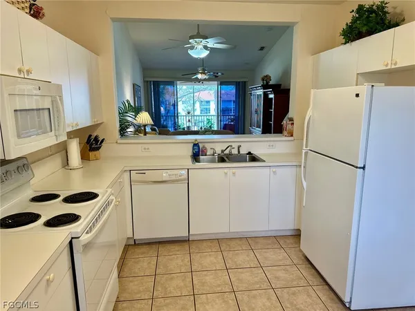 a kitchen with a sink a refrigerator a stove a washer and dryer