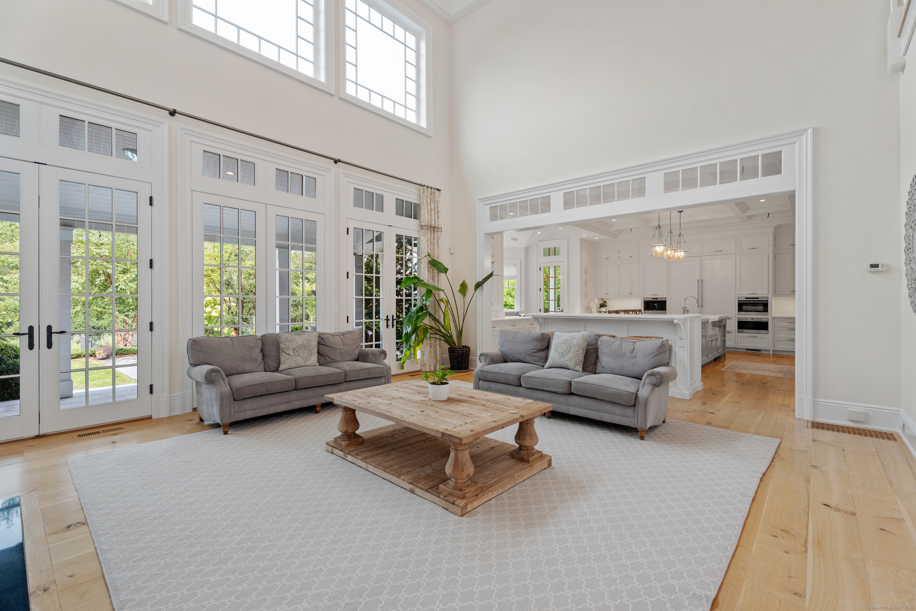 294 Maple Road Easton, CT 06612 - Photo 4 of 40 This stunning two-story family room impresses with soaring ceilings and an abundance of natural light. Its open-concept design flows seamlessly into the kitchen.