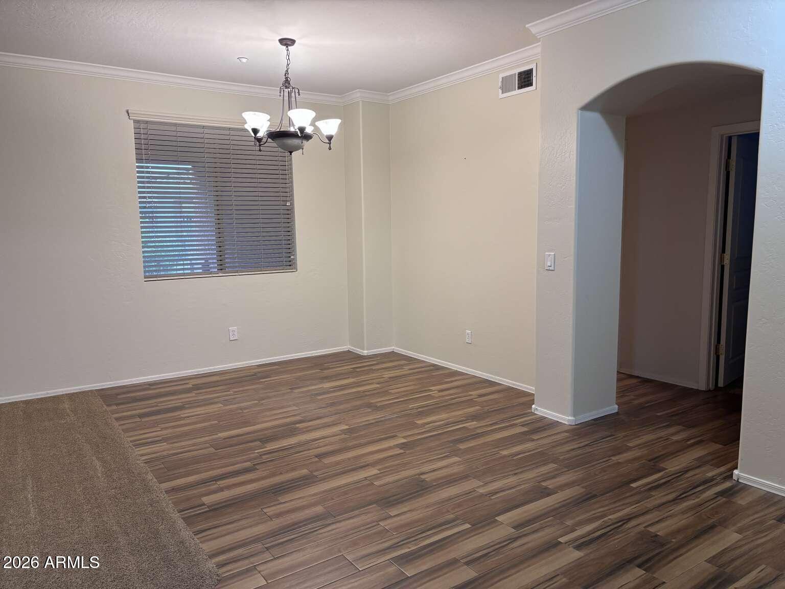 955 East Knox Road, Unit 118 Chandler, AZ 85225 - Photo 27 of 46 a view of a chandelier in big room with wooden floor