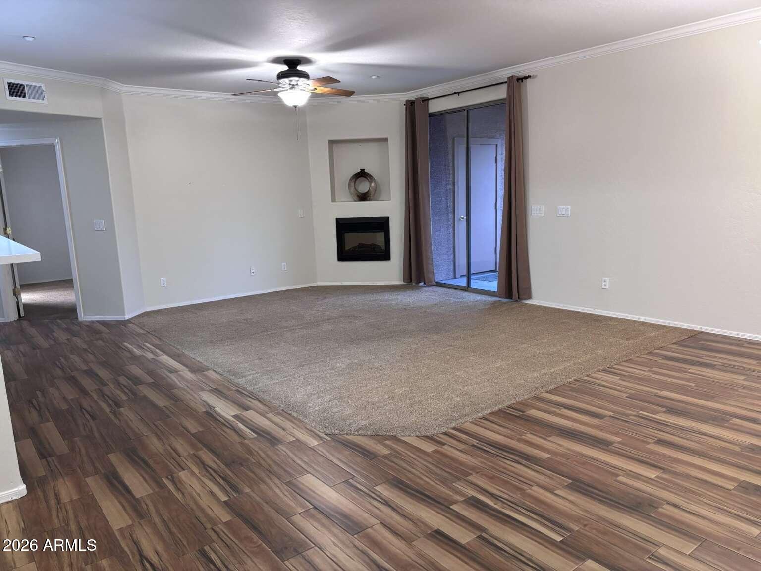 955 East Knox Road, Unit 118 Chandler, AZ 85225 - Photo 3 of 46 a view of empty room with fireplace and wooden floor