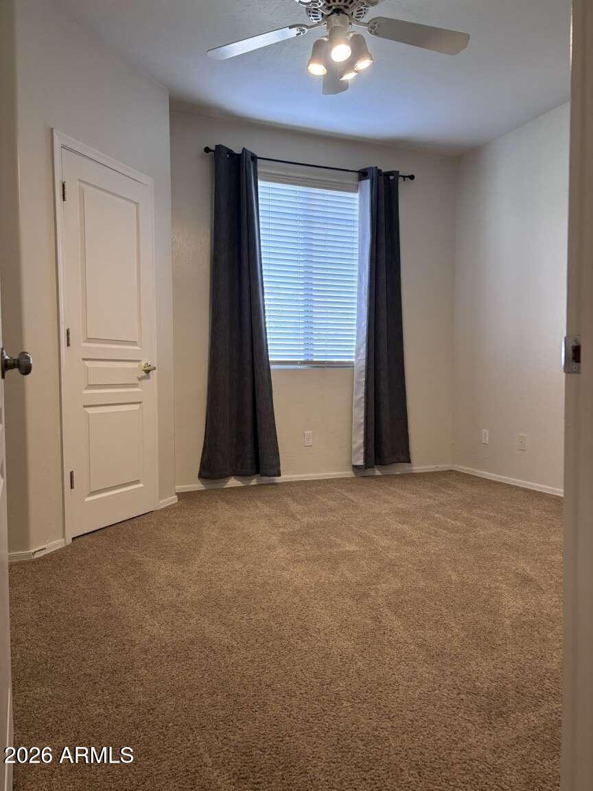 955 East Knox Road, Unit 118 Chandler, AZ 85225 - Photo 34 of 46 an empty room with a ceiling fan