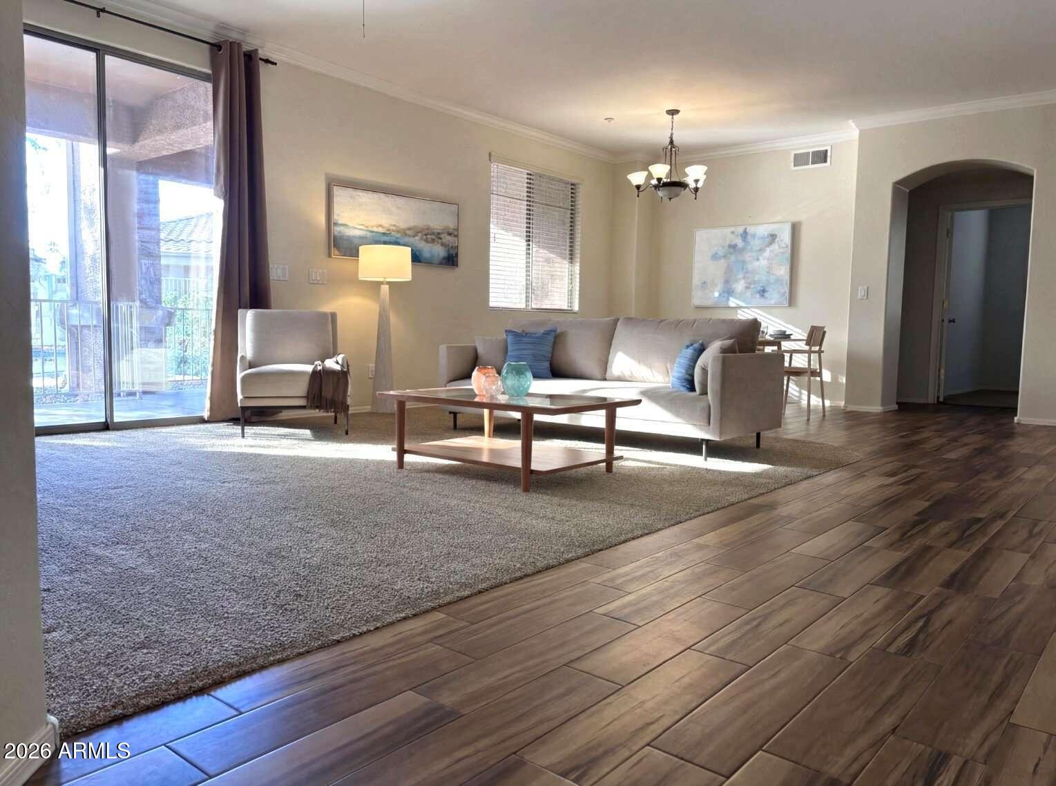 955 East Knox Road, Unit 118 Chandler, AZ 85225 - Photo 4 of 46 a living room with furniture and a chandelier