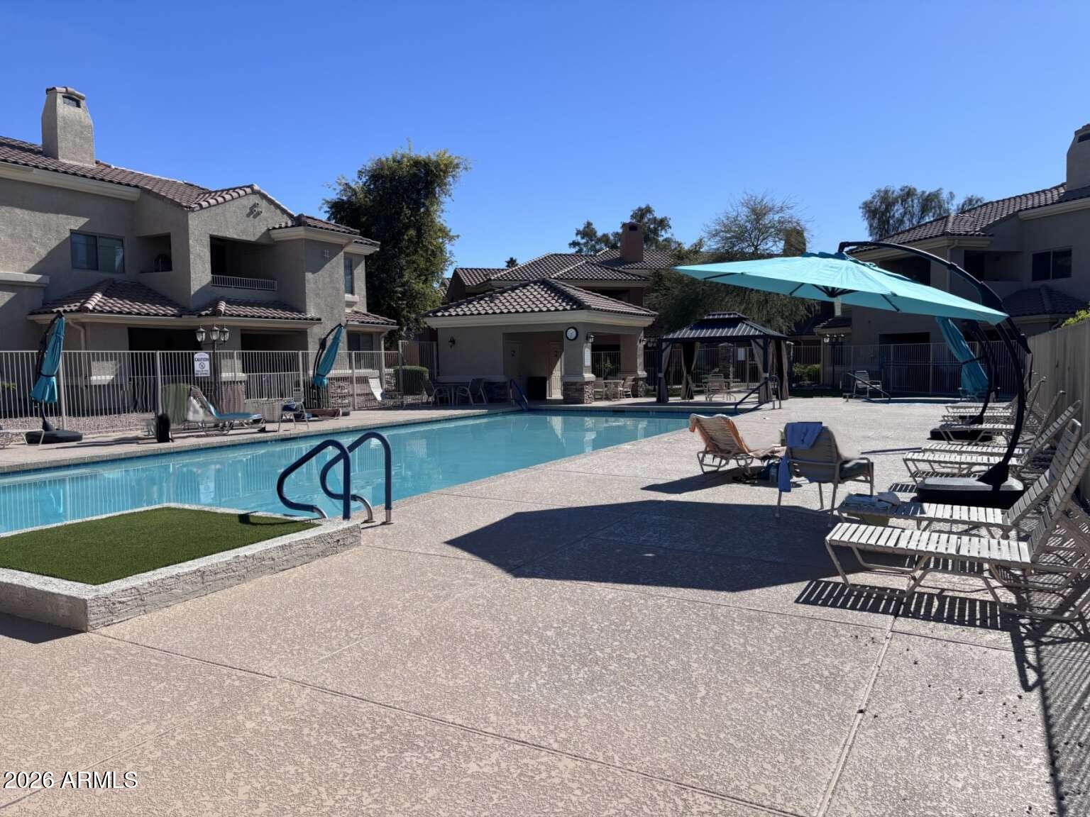 955 East Knox Road, Unit 118 Chandler, AZ 85225 - Photo 45 of 46 a view of a house with swimming pool and sitting area