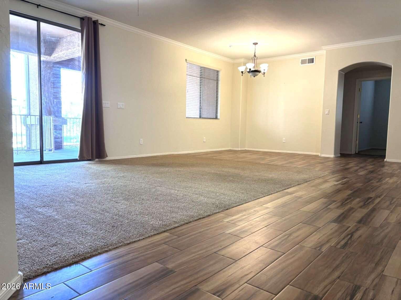 955 East Knox Road, Unit 118 Chandler, AZ 85225 - Photo 5 of 46 an empty room with wooden floor and windows