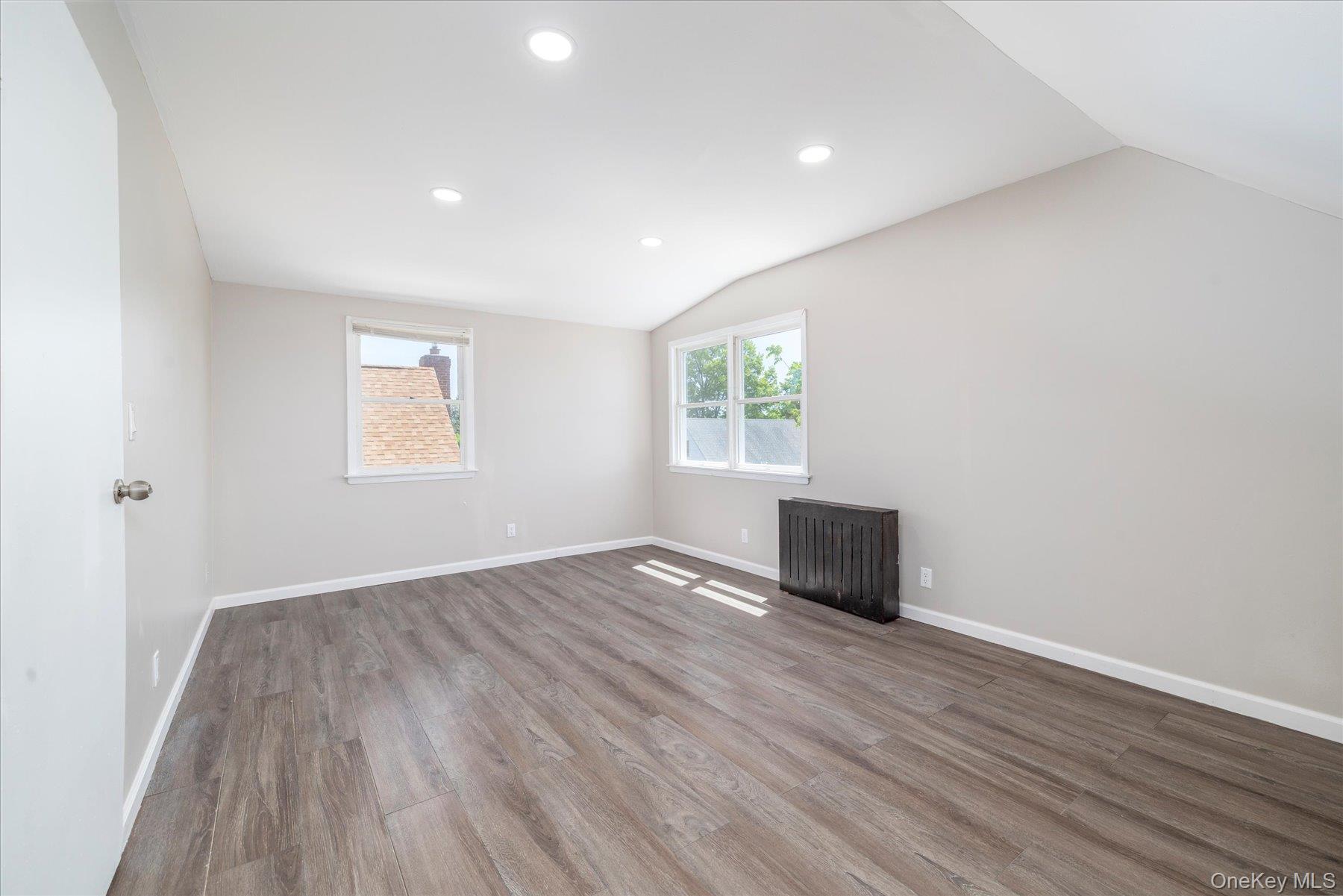 191 Raff Avenue Mineola, NY 11501 - Photo 24 of 25 an empty room with wooden floor and windows
