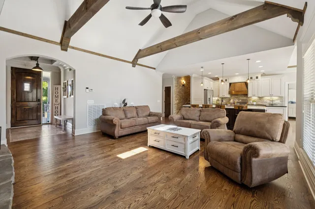 a kitchen with stainless steel appliances granite countertop a sink a stove and a refrigerator