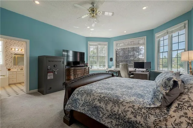 a spacious bedroom with a bed and wooden floor