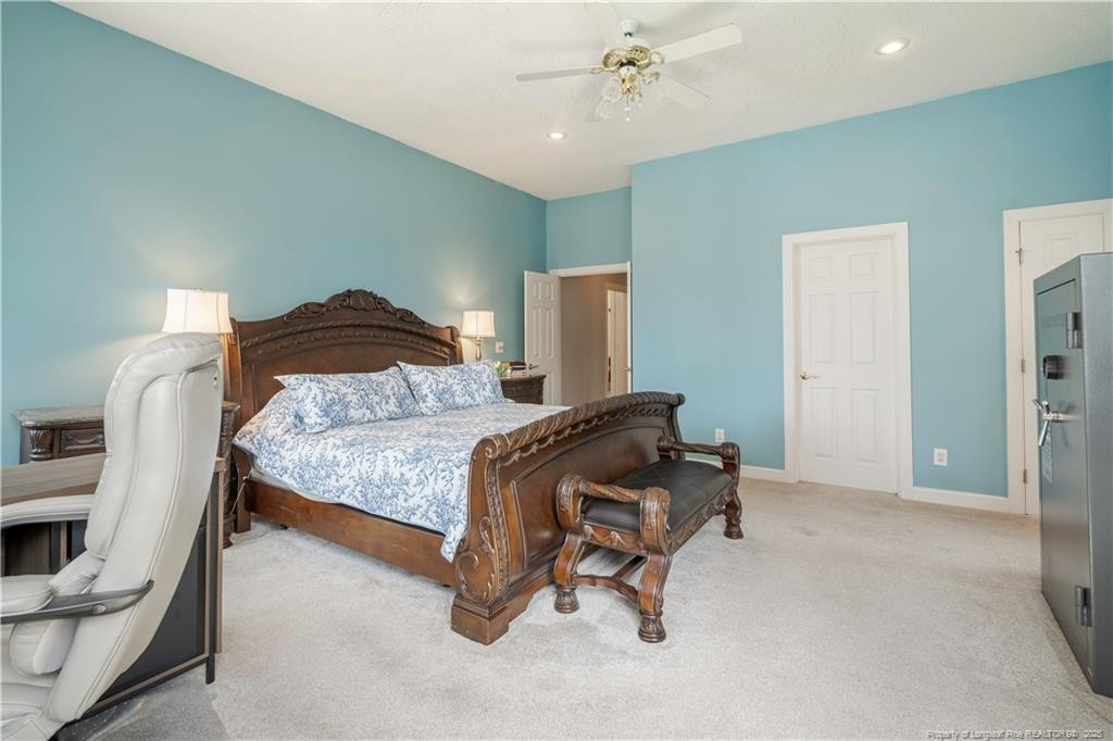 515 Briarwood Road Warsaw, NC 28398 - Photo 15 of 36 a bedroom with a bed and a chandelier