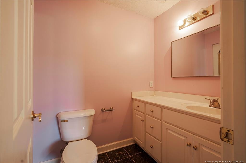 515 Briarwood Road Warsaw, NC 28398 - Photo 23 of 36 a bathroom with a toilet sink and mirror