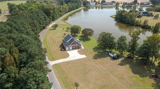 an aerial view of a house with a lake view